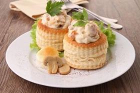 Timbale en pâte feuilletée garnie de poulet dans une sauce blanche aux champignons